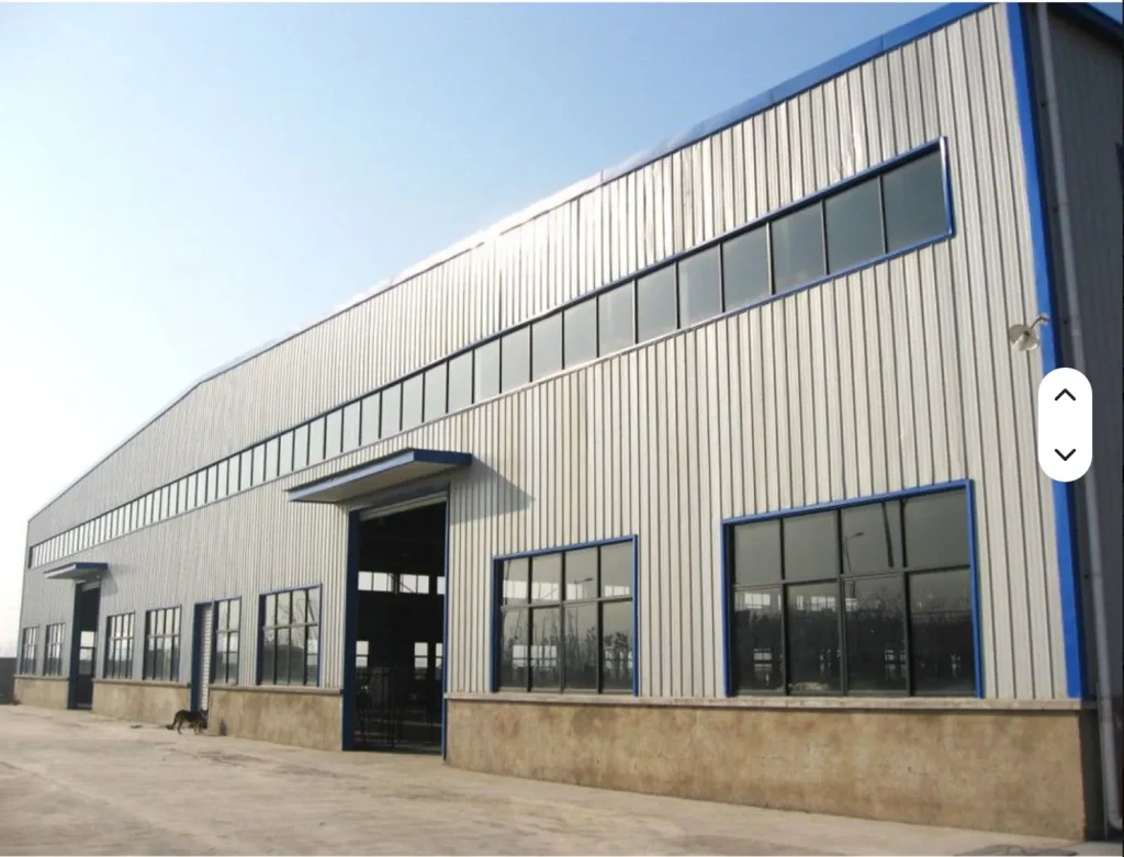 PEB Building Cost in UAE 2026: Steel Warehouse & Factory Price Guide (Dubai, Abu Dhabi) Completed steel structure industrial building with blue trim